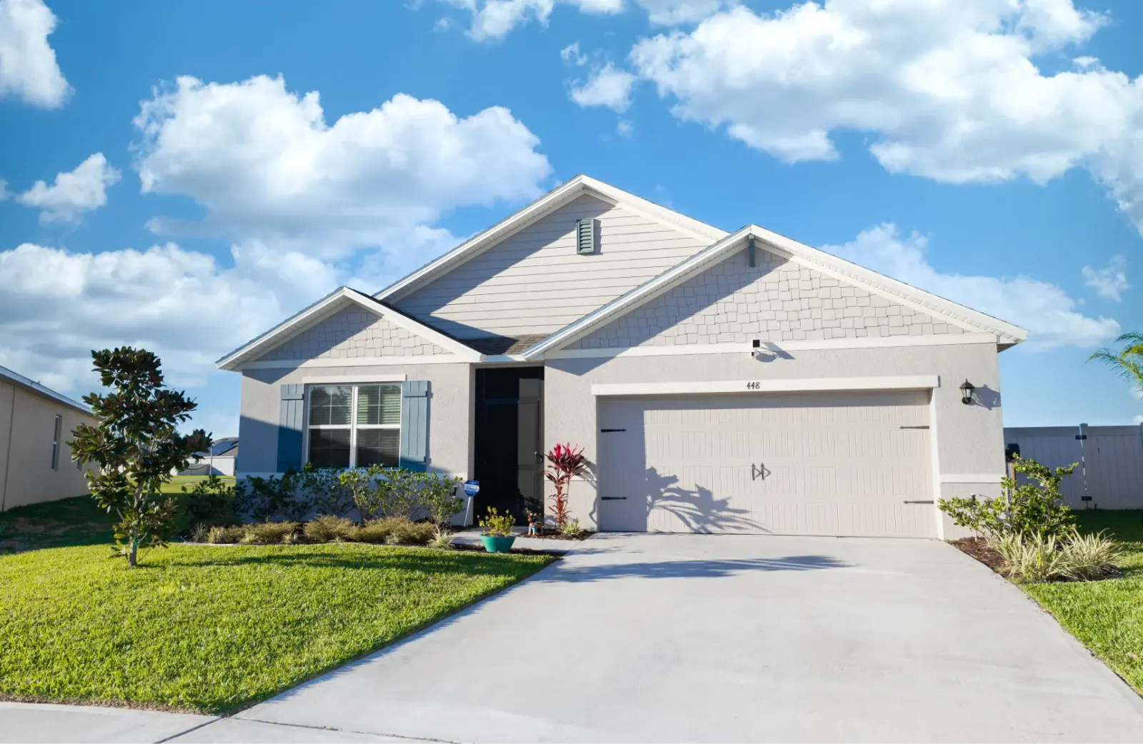 Charming single-story home with a well-manicured lawn.